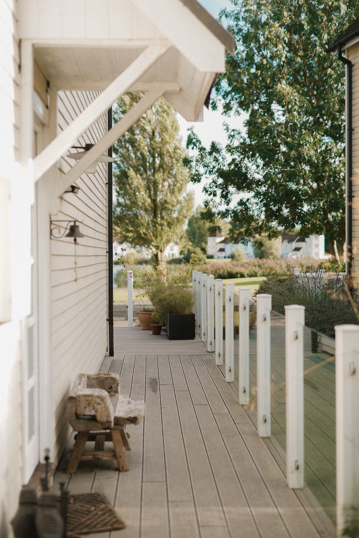 The weatherboarded veranda of a home in South Cerney, looking out over the lake